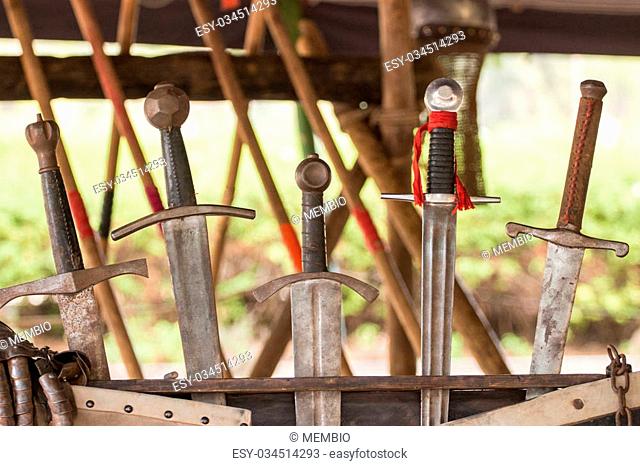 Close up view of a row of medieval swords