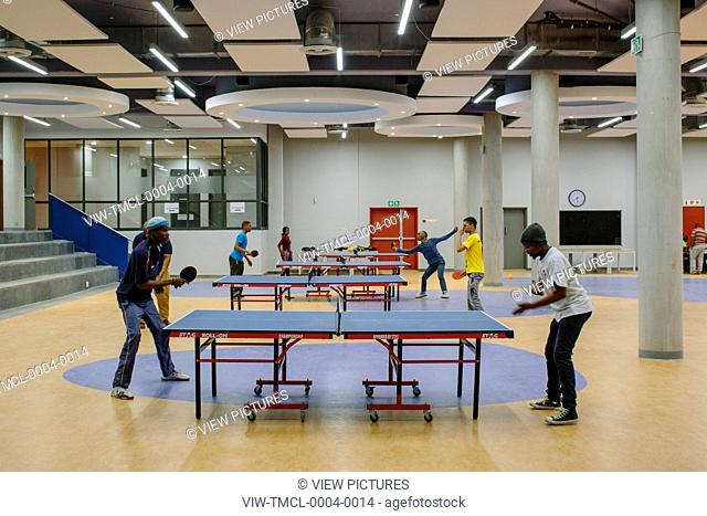 Multi-purpose hall with students playing table tennis. Sol Plaatjie University, C002, Kimberley, South Africa. Architect: Savage + Dodd Architects, 2016