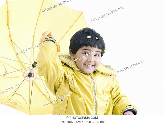 Portrait of a girl throwing an umbrella