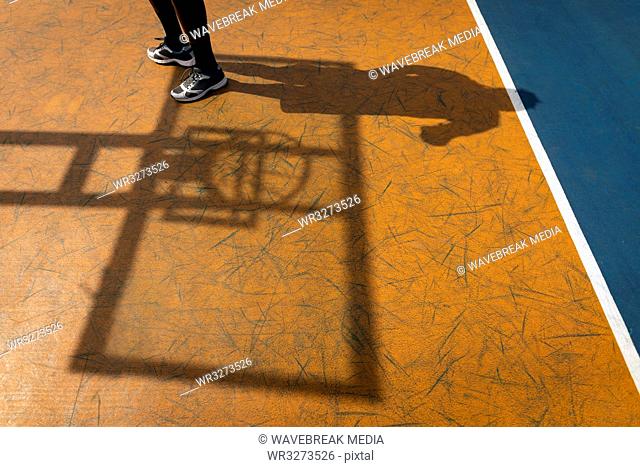 Basketball player standing at basketball court