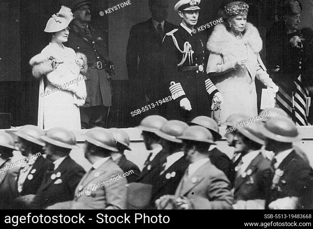 King Takes The Salute At Great National Services Rally -- Steel helmeted A.R.P. warders marching past the King and Queen and Queen Mary standing on the saluting...