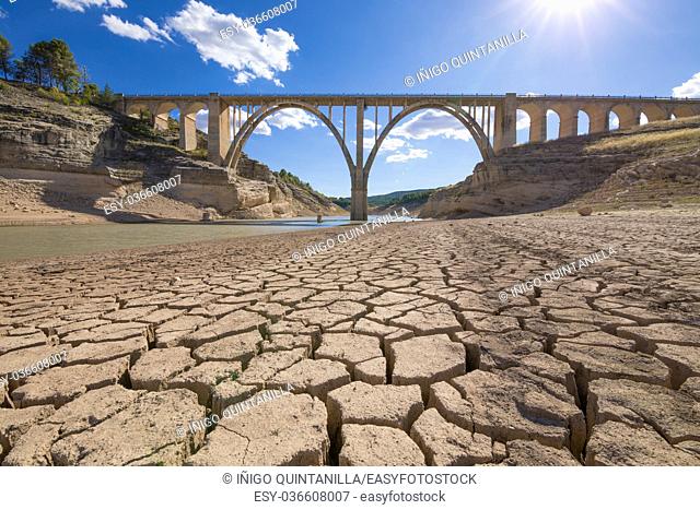 landscape of dry earth ground and viaduct, extreme drought in Entrepenas reservoir, in Guadalajara, Castilla, Spain Europe