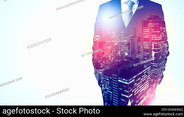Young businessman standing and thinking with night city background
