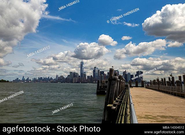 LIBERTY ISLAND, New York City, NY, USA, a dramatic sky and a zeppelin over New York City Skyline of New York City, Lower Manhattan and a dramatic sky with a...