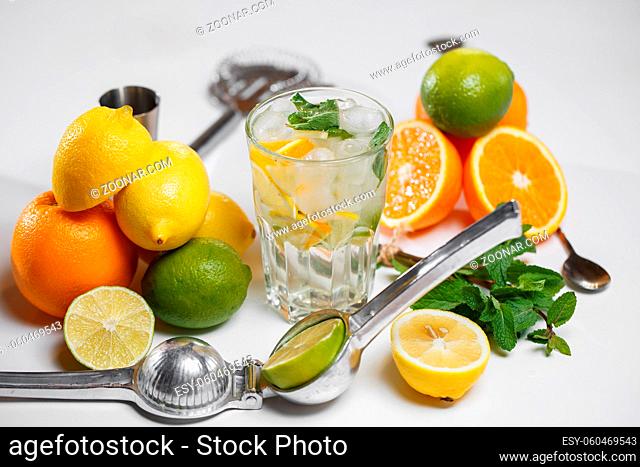 Sports glass Water with Lemon, Lime, and Mint on white table