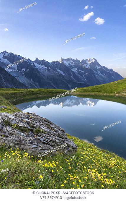 The Mont Blanc Massif reflected in the Checrouit Lake at sunset during the Mont Blanc hiking tours (Veny Valley, Courmayeur, Aosta province, Aosta Valley, Italy