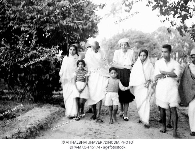 Sushila Nayar ; Mahatma Gandhi and others walking at Khadi Pratishthan ; Sodepur ; 24 Parganas ; Calcutta ; 1946 Dhirendra Chatterjee Abha Gandhi's brother ;...