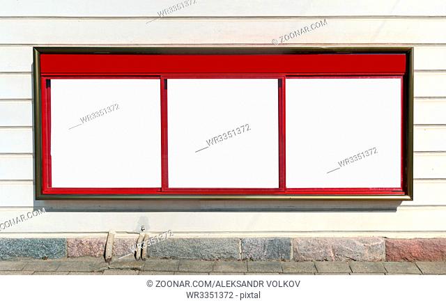 A large red city information billboard hangs on the wall of an old house. Glas isolated with white