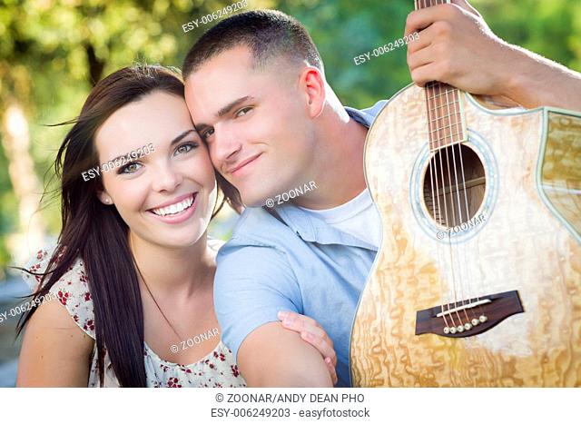 Mixed Race Couple Portrait with Guitar in Park