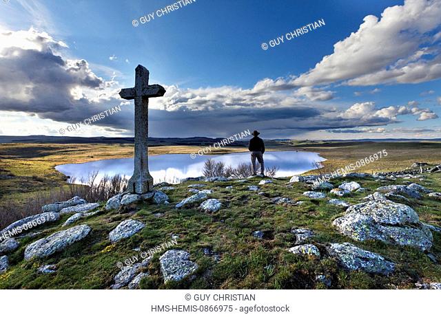 France, Lozere, Aubrac Plateau, hiker at Lake St. Andeol on the Route of Compostela