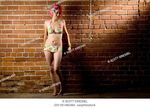Woman in a bikini on brick