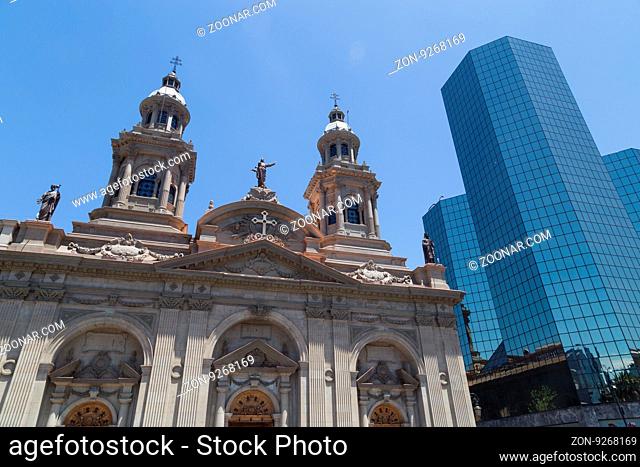 Santiago de Chile, Chile - November 26, 2015: The cathedral at the main square next to a modern building in Santiago de Chile
