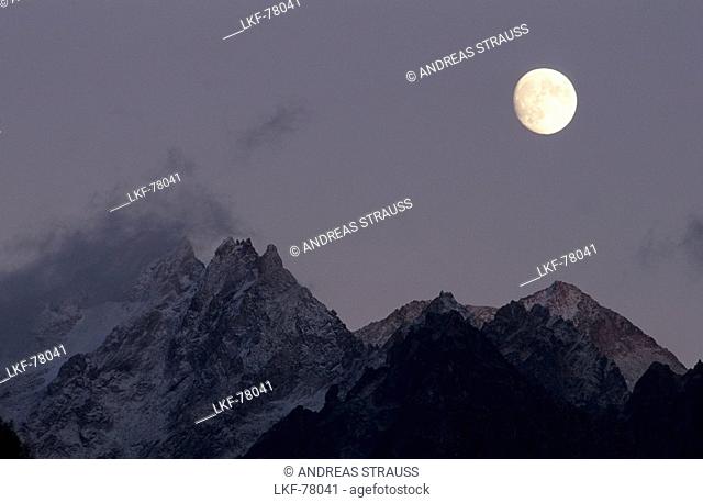 moon above granite pinnacles of Bergell, Soglio, Bergell, Grisons, Switzerland