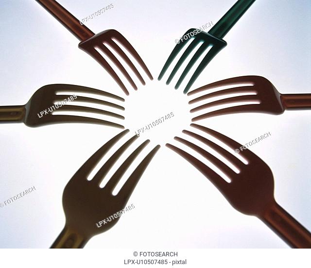 Six forks reaching toward center, high angle view, close up, white background