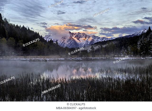 Corno Baitone, southernmost peak of Adamello range, reflects on a lake in Pian di Gembro natural reserve, Aprica, province of Sondrio, Lombardy, Italy