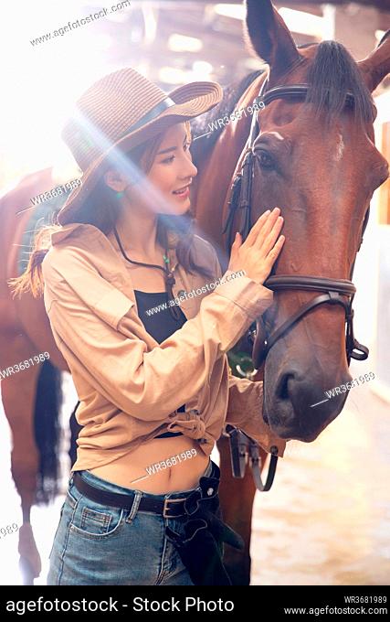 Happy young woman touch steed