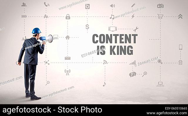 Engineer working on a new social media platform with CONTENT IS KING inscription concept