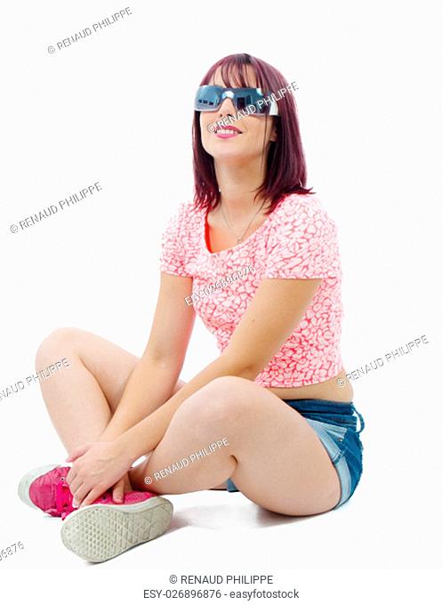 a pretty young woman sitting cross-legged on white background