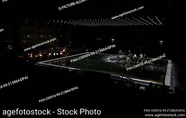 15 September 2023, Berlin: Members of the ensemble at the photo rehearsal in a scene of the opera ""Das Floß der Medusa"" in Hangar 1 on the grounds of the...