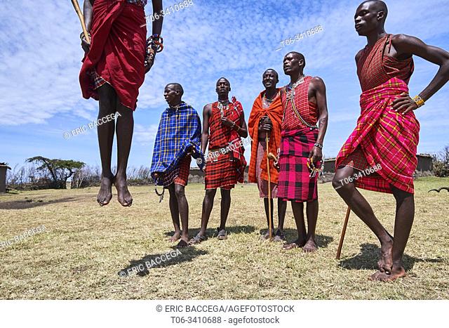 Young Maasai men performing a traditional jumping dance, Masai Mara National Reserve, Kenya