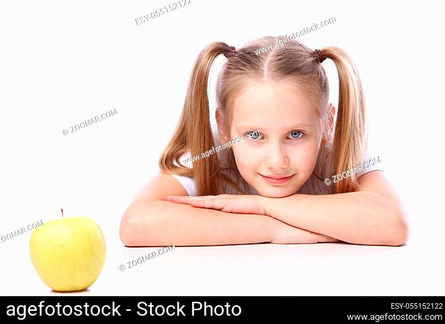 Cute girl with fresh apple over white background