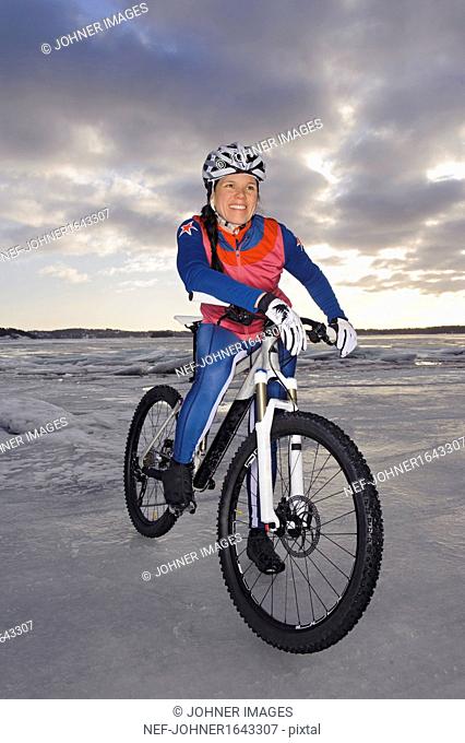 Smiling mid adult woman on mountain bike