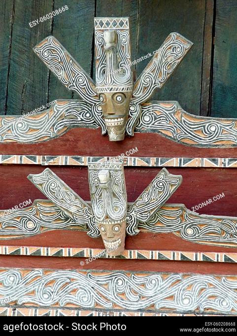 Carving of figure of Batak hunter with traditional colours and design of that ethnic group from the Indonesian island of Sumatra. High quality photo