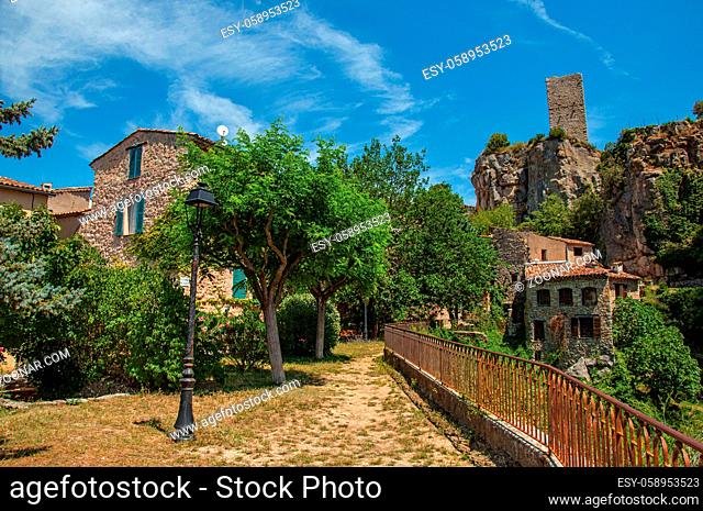View of houses facing the garden and cliff in Chateaudouble, a quiet and tourist village with medieval origin on a sunny day