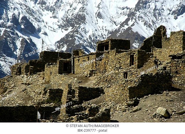 Nested stone houses in front of snow-covered mountain slope of Pisang Peak Chyakhu Nar-Phu Annapurna Region Nepal