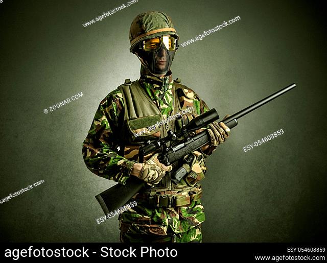 Soldier agent in a dark room with arms on his hand and gas mask