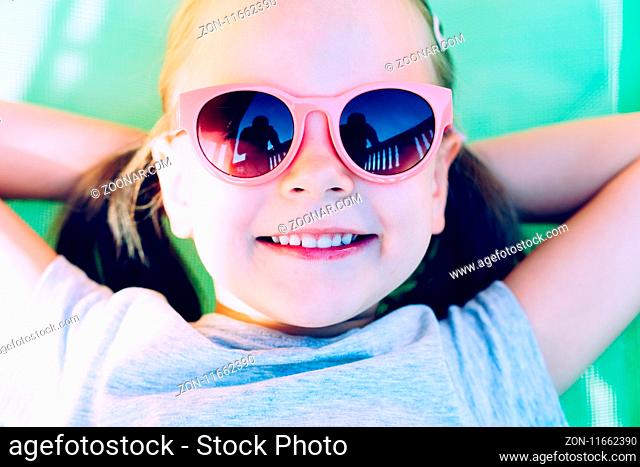 Close-up Of A Young Happy Little Girl Lying In Hammock