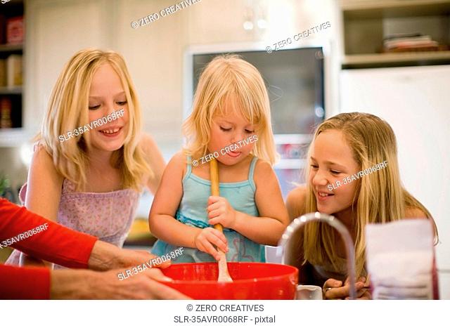 Sisters cooking together in kitchen