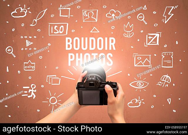 Hand taking picture with digital camera and BOUDOIR PHOTOS inscription, camera settings concept
