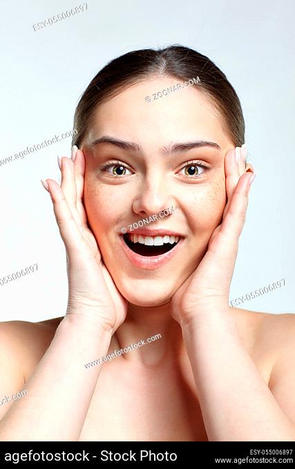 Emotional young woman face portrait with wonder facial expression. Human female natural emotions and expressions concept