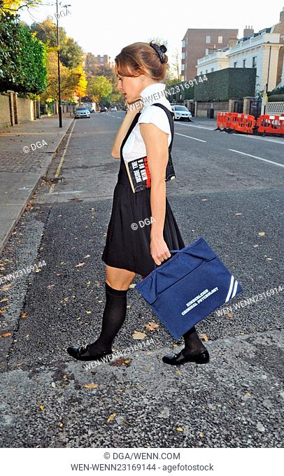 TV presenter and criminal psychologist, Kim Frickleton talks on her mobile phone after a class. The Cambridge University graduate dressed in a school girl...