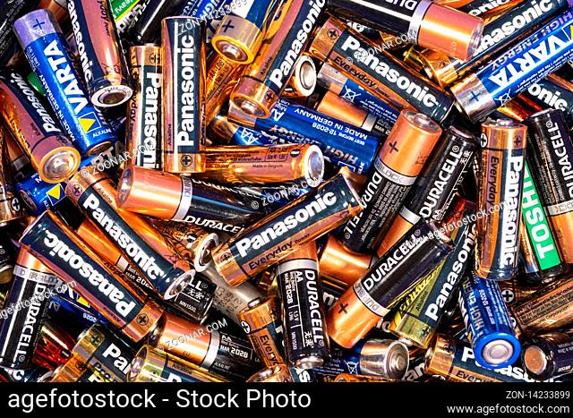 Sofia, Bulgaria - 11 August 2019: Multiple used AA alkaline batteries are seen in a pile. Toshiba, Philips, Varta, Duracell, Panasonic batteries