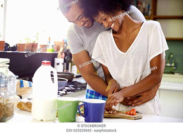 Young Couple Preparing Breakfast In Kitchen Together