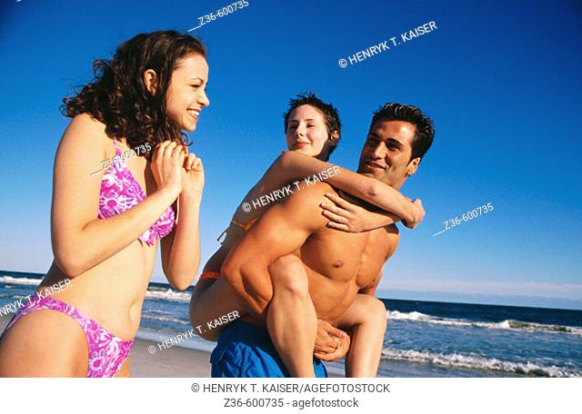 Two girls and one boy at a beach