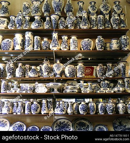 A display of traditional blue and white delft pottery in the typical traditional style of the region. Delftware is an example of tin glaze pottery