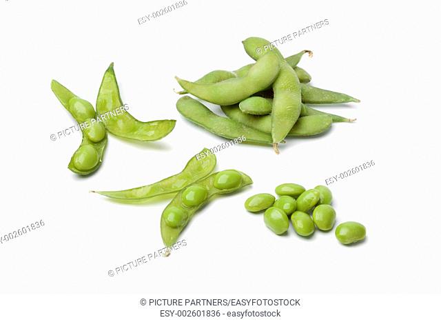 Fresh soybeans and pods on white background