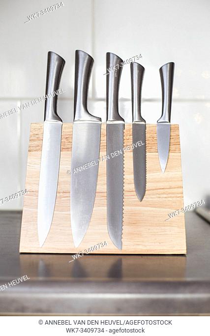 knives with magnet wood block on the kitchen counter, modern design clean and new