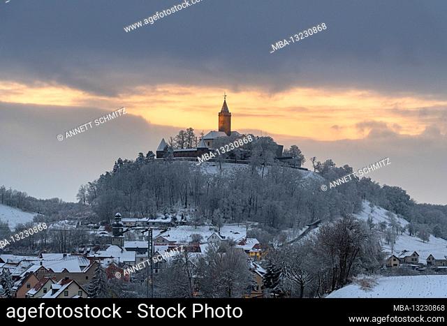 Sunset behind the snow-covered Leuchtenburg in Thuringia