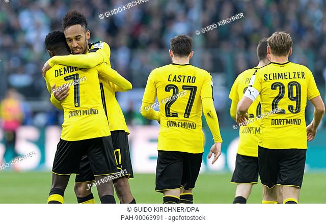 Dortmund's Pierre-Emerick Aubameyang (2-L) cheers over his 2-2 score with teammate Ousmane Dembele (L) during the German Bundesliga soccer match between...