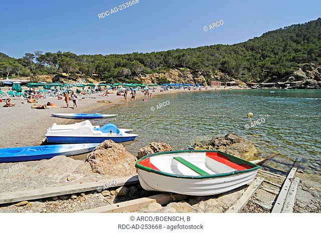 Boats and vacationists at beach bay Cala Benirras Ibiza Pityuses Balearic Islands Spain San Juan Bautista slipway