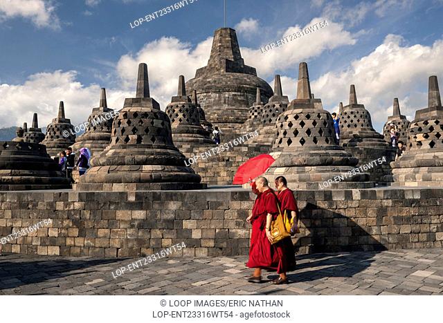 Monks walking around the stupa of Borobodur a 9th century Buddhist Temple in Magelang near Yogyakarta in central Java in Indonesia