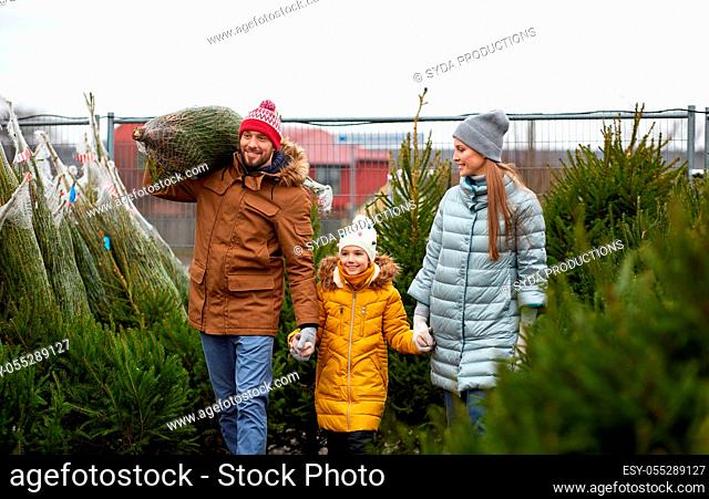 happy family buying christmas tree at market