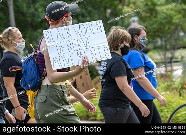 St. Paul, Minnesota, Youth march and rally to end violence, Protester holding a black women deserve movements sign at the rally.