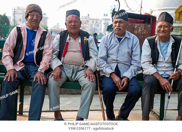 Nepalese men taking a breath at the foot of Swayambhunath Stupa, Kathmandu