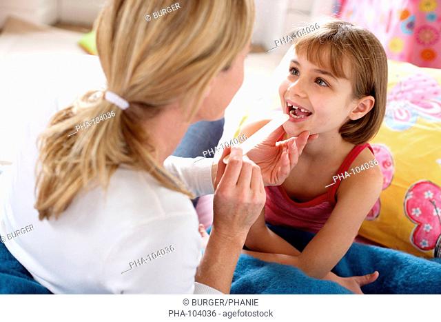 Doctor examining the throat of a 7 years old girl