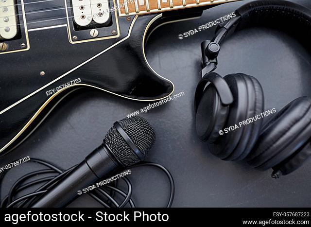 close up of bass guitar, microphone and headphones